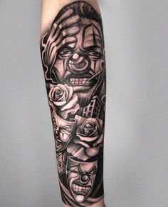 a man's arm with tattoos on it, including roses and an evil face