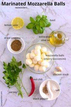 ingredients to make marinated mozzarella balls on a marble countertop with text overlay