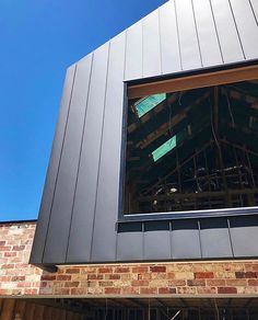 an open window on the side of a brick building with scaffolding around it