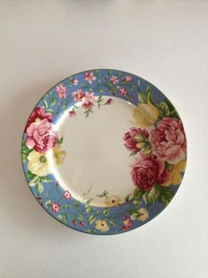 a blue and pink plate with flowers on it