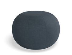 a dark blue round ottoman sitting on top of a white floor