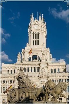 an ornate building with statues in front of it