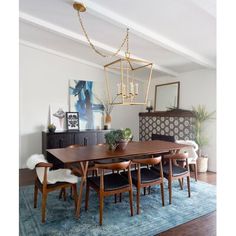 a dining room table with chairs and a rug