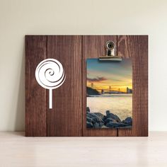 a wooden frame with an image of a lollipop on the front and side