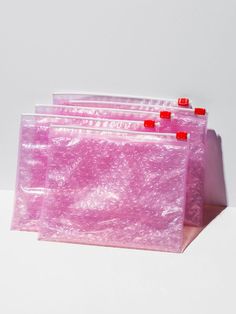 pink bags lined up on top of each other