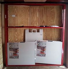 the inside of a storage room with two refrigerators