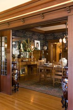 a dining room with wooden floors and walls