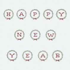 the words happy new year are arranged in wreaths