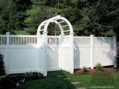 a white fence with an arch over it