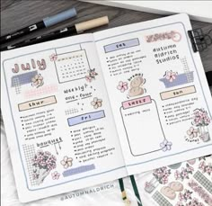 an open planner with flowers on it next to some pens and pencils, along with other items