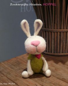 a stuffed rabbit sitting on top of a wooden table