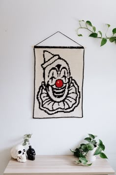 a wall hanging with a clown face on it