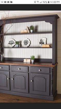 an old china cabinet is painted in dark gray