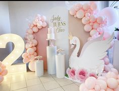 balloons and decorations are arranged in the shape of swans