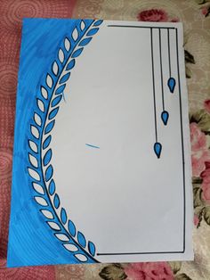 a piece of paper that has been cut out to look like a circle with blue and white designs on it