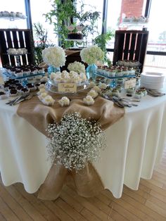 a table topped with lots of desserts and cupcakes on top of it