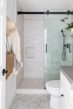 a bathroom with a shower, toilet and sink in it's center piece is shown