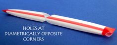 two red and white toothbrushes on a blue surface with the words holes at diametrically opposite corners