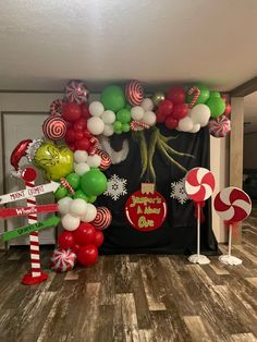 the balloon arch is decorated with candy canes, lollipops and christmas decorations