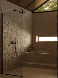 a bathroom with a walk in shower next to a window