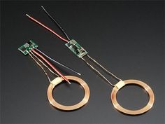 two different types of electronic components on a black surface with wires and connectors connected to them