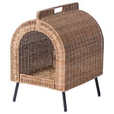 a wicker dog house with black legs