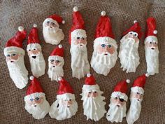 a group of santa clause figurines sitting on top of a brown cloth covered floor