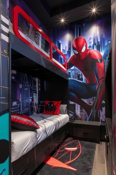 a bedroom with a spiderman mural on the wall and bunk beds in front of it