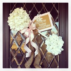 a door with flowers and a welcome sign on it