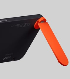 an orange and black cell phone holder attached to it's back side, with the cover partially open