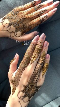 two hands with henna tattoos on them