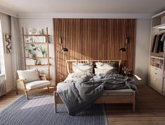 a bed sitting in a bedroom next to a wooden shelf filled with books and pillows