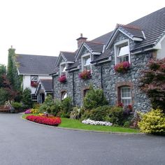 a house with flowers in the front yard