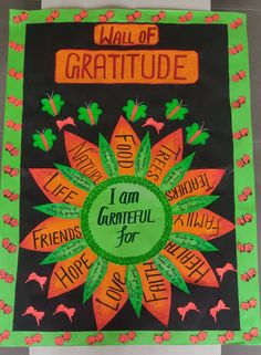 a bulletin board with the words i am grateful for written in orange, green and black