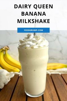 a banana milkshake with whipped cream on top and two bananas in the background