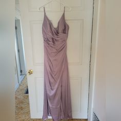 a dress hanging up on a door