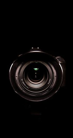 a camera lens is shown in the dark