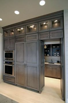 a kitchen with wooden cabinets and stainless steel appliances