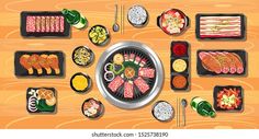 an overhead view of sushi dishes and chopsticks on a wooden table top