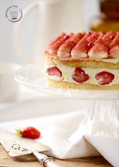 a cake with strawberries on top is sitting on a plate