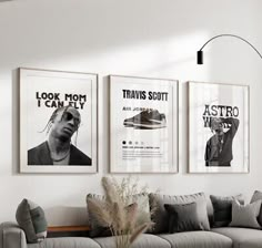 a living room filled with furniture and posters on the wall above it's couch