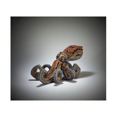 an intricately carved wooden sculpture of a lizard on wheels, with its head turned to the side