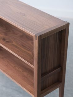 a close up of a wooden shelf on the floor with no one around it or in front of it