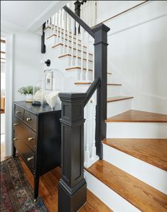 the stairs in this house have been painted black and white with wood trimmings