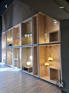 an empty room with several shelves and lamps