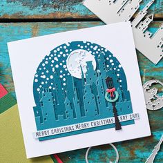 a christmas card with a city scene on it