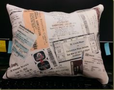 a pillow with tickets on it sitting in front of a computer keyboard that is turned upside down