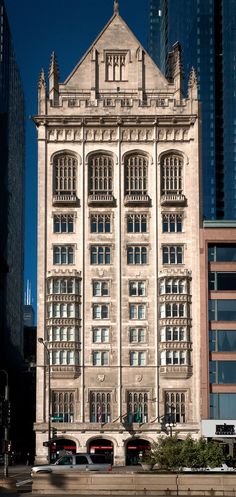 an old building in the middle of some tall buildings