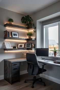 a desk with a computer and some plants on it in front of a large window