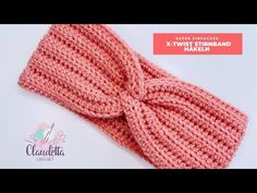 a crocheted headband with a knot on top is shown in light pink